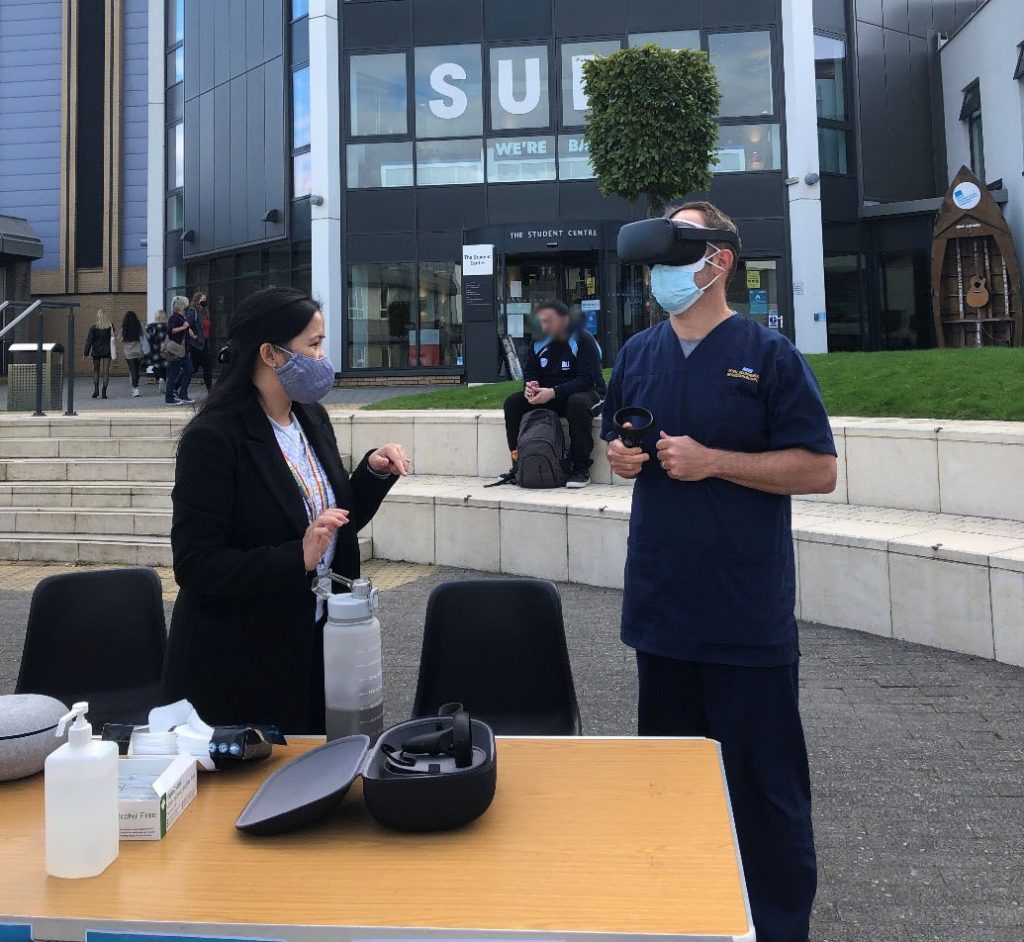Staff assisting a participant with using the Oculus Quest