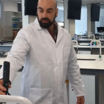 Man in lab coat holding 360 camera