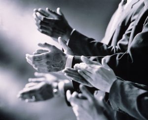 Black and white photo of hands clapping
