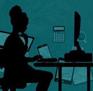 Silhouette of woman at computer screen