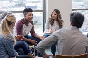 4 students seated in a circle