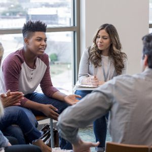 4 students seated in a circle