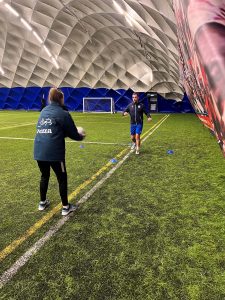 Leah Jordan-Cooper training with a footballer