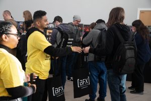 BFX ambassadors hand out merchandise to attendees
