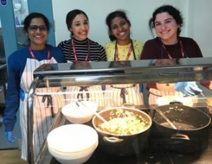 Madhurya and three other course mates standing behind a food serving station