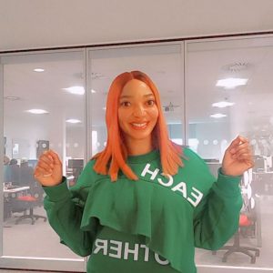 Student Esther poses in a bright green jumper on Talbot Campus