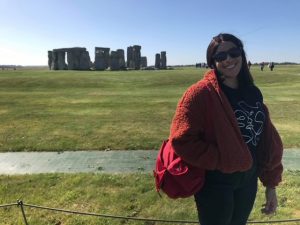 Student Zoey photographed on a sunny day in front of Heritage site Stone Henge.