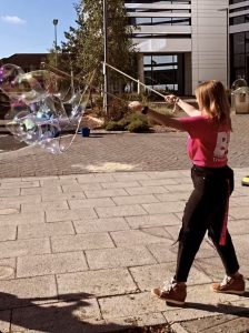 Katy assisting a bubble artist 