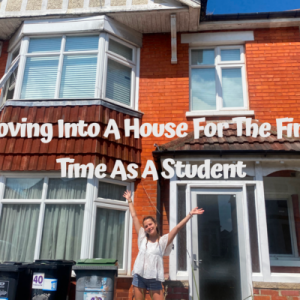 Mia standing with her arms in the air in front of a house with the words Moving into a house for the first time as a student