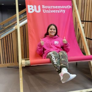 A female student sitting in a big BU deckchair