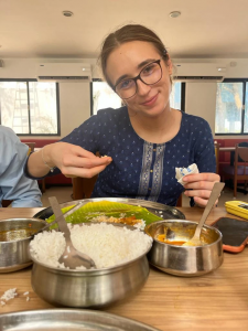 Student eating Indian food 