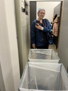 Student on placement in front of scrub bins