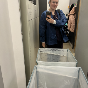 Student on placement in front of scrub bins