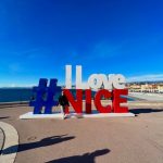 Zoe standing in front of a big #I Love Nice sign