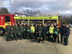 Emergency Service personnel in front of a fire service truck