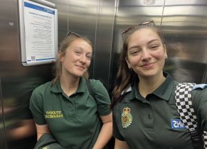 Two women in a lift smiling 