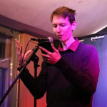 András Dávid Fasimon. Credits for the photo go to Elena Chamberlain from Chimes Poetry Night.