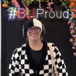 Juan smiling and posing behind a ‘BUProud’ frame at Bournemouth University.