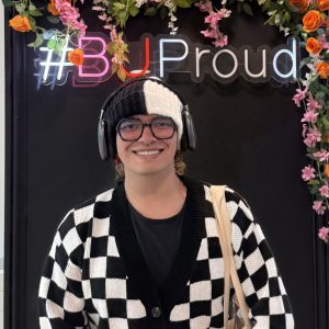 Juan smiling and posing behind a ‘BUProud’ frame at Bournemouth University.