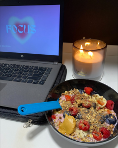 Healthy dinner, candle and laptop.